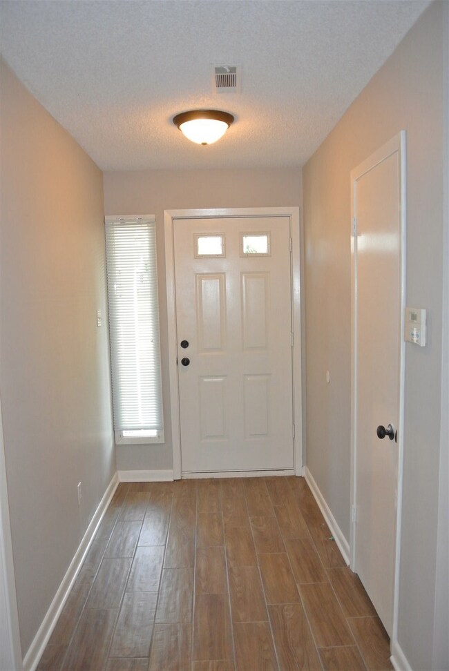 Entry hall with coat closet and new tile floors wi