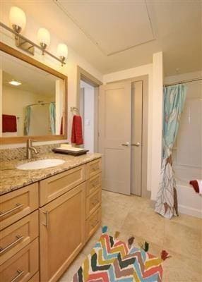 Full bath with vanity, shower / bathtub combination with curtain, and light tile patterned floors