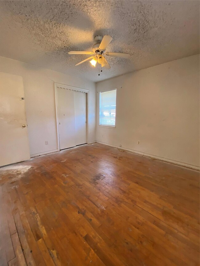 Unfurnished bedroom with ceiling fan, a closet, wo