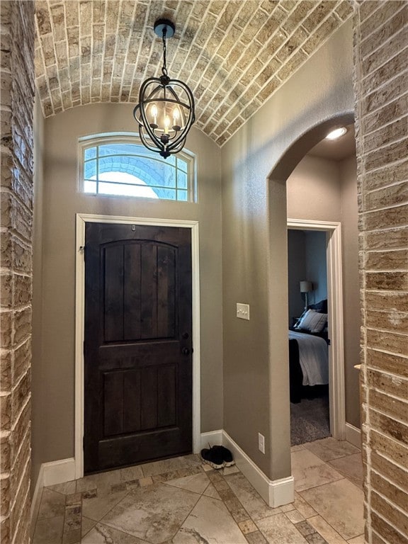 Entrance foyer featuring arched walkways, vaulted