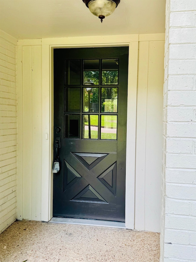 View of exterior entry with brick siding