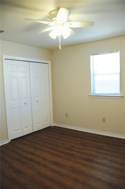 Rear bedroom with double closets and wood laminate floors . Has adjoining bathroom in pristine condition.