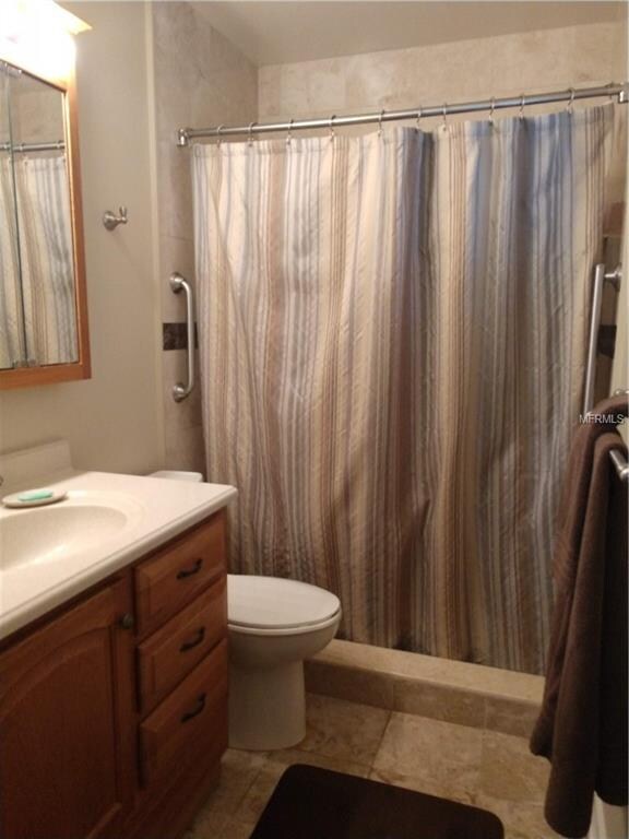 Private master bath includes tile floor, vanity co