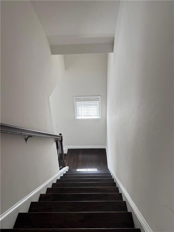 Stairway featuring wood finished floors and baseboards