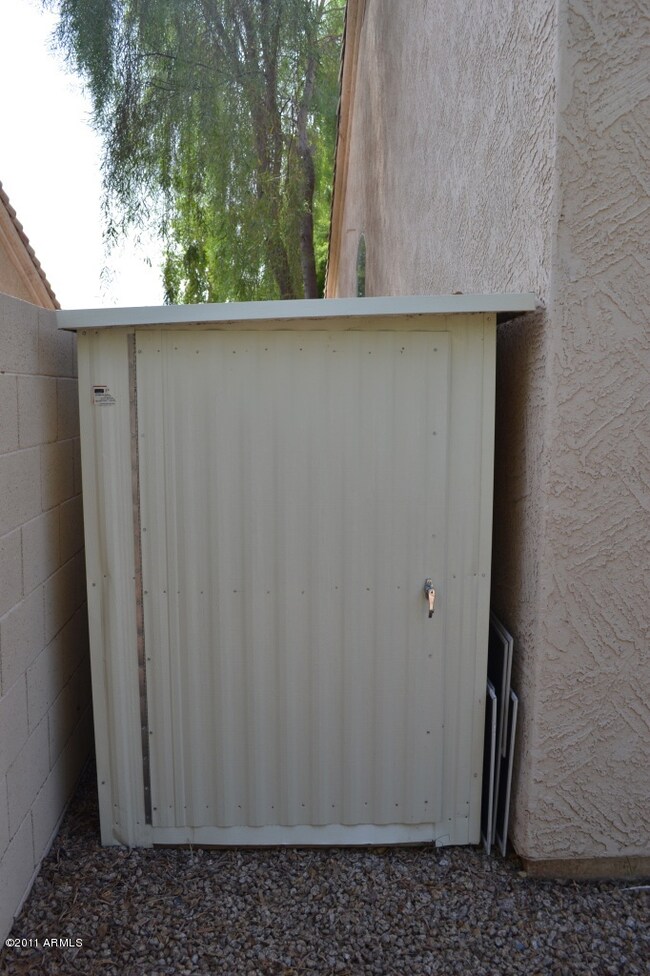 Shed in backyard between E fence & house