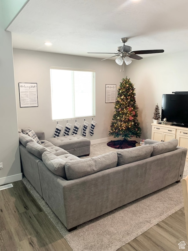 Living area featuring wood finished floors, recessed lighting, and ceiling fan