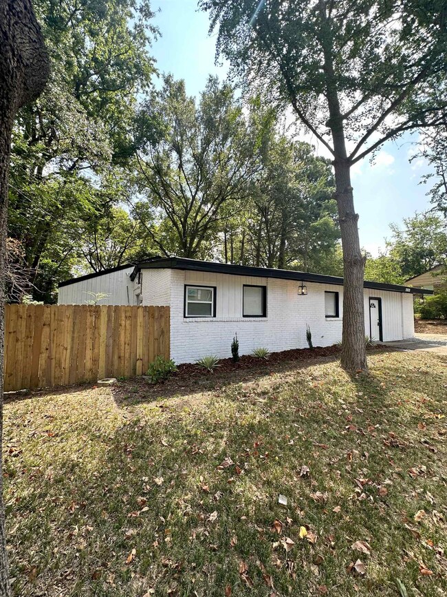 View of property exterior featuring a lawn