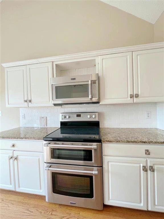 Kitchen featuring tasteful backsplash, white cabin