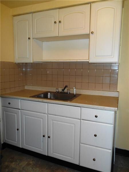 Newer, white kitchen cabinetry.