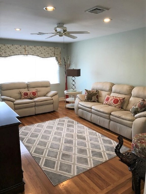 Spacious Living Room with Gleaming Hardwood Floori