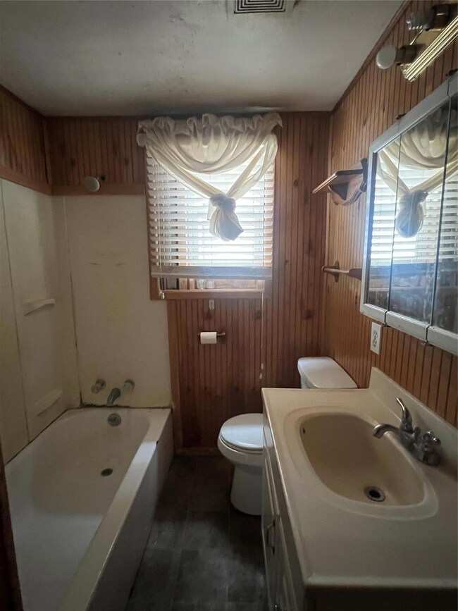 Full bathroom featuring vanity,  shower combinatio