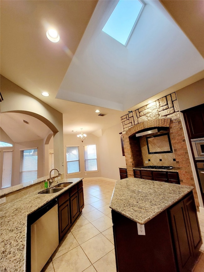 High ceiling in kitchen has skylight.