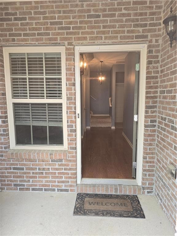 Entrance to property with brick siding
