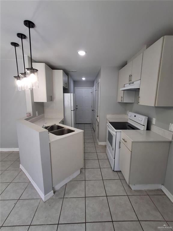 Kitchen with white appliances, white cabinets, light tile patterned floors, light countertops, and under cabinet range hood