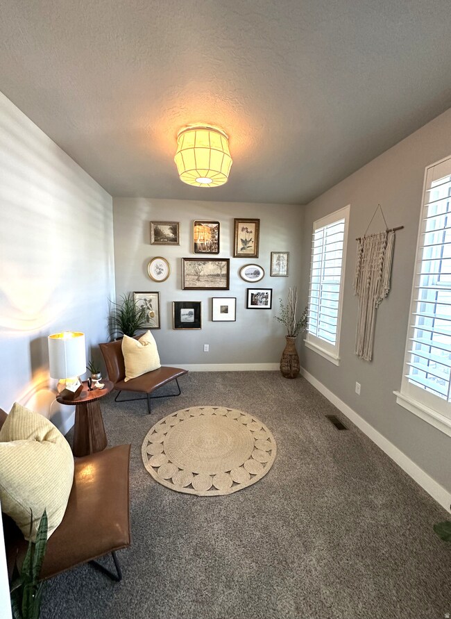 Living area with a textured ceiling and carpet floors