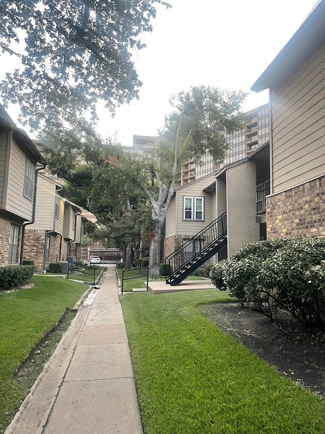 View of community with a lawn, stairway, a balcony, and a residential view