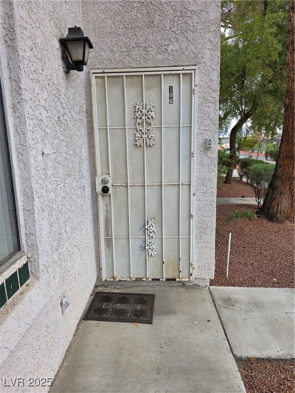 View of exterior entry featuring stucco siding