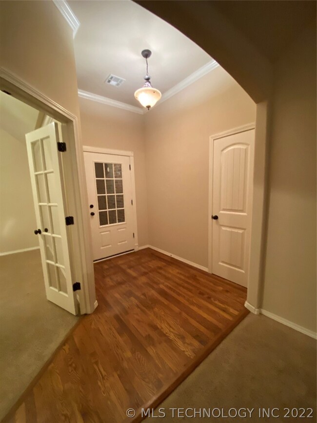 Arched entry with office separate from bedroom are