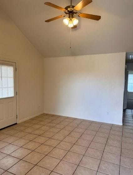 Empty room featuring vaulted ceiling and ceiling f