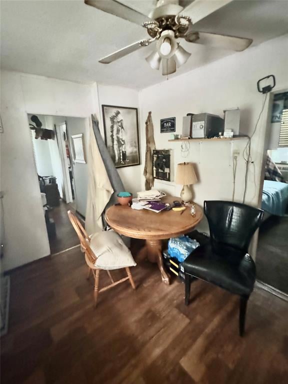 Dining room featuring wood finished floors and ceiling fan