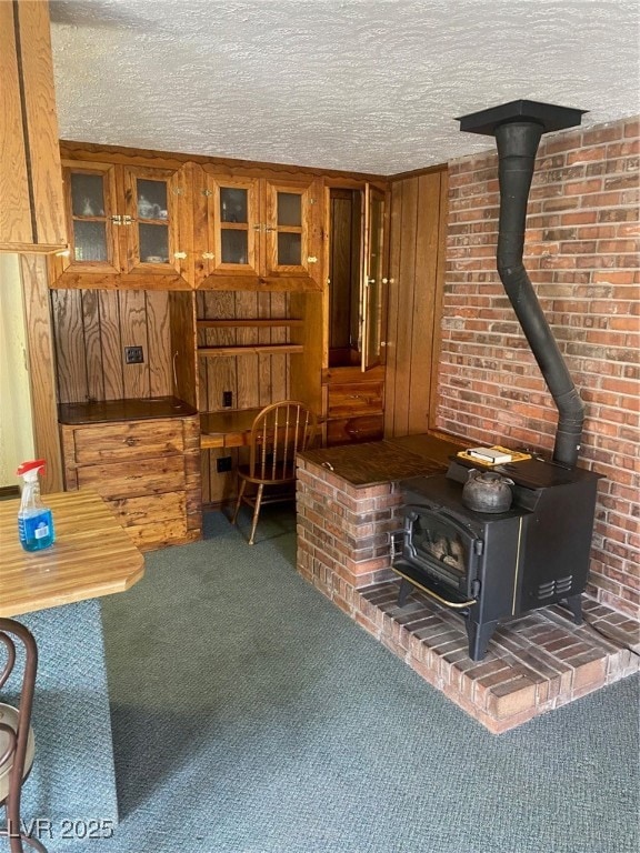 Living room with a wood stove, carpet, and a textu