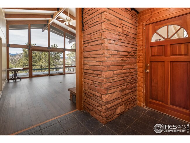 Beautiful entry accents of flagstone, tile and wood into great room