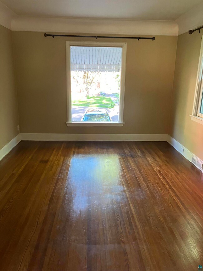 Spare room with dark hardwood / wood-style floors