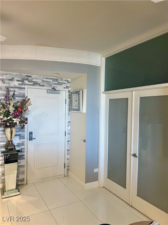 Entrance foyer with light tile patterned flooring