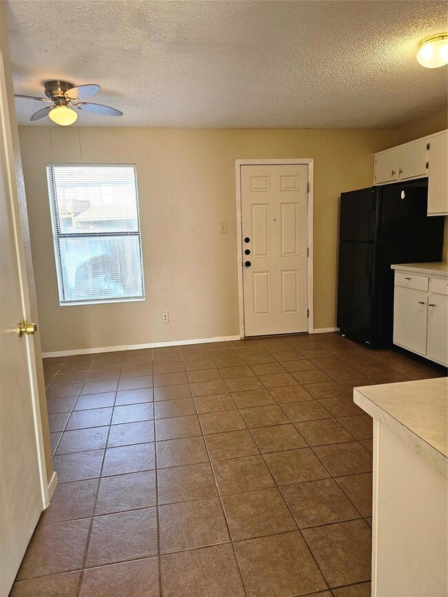 Kitchen with refrigerator, a textured ceiling, dar