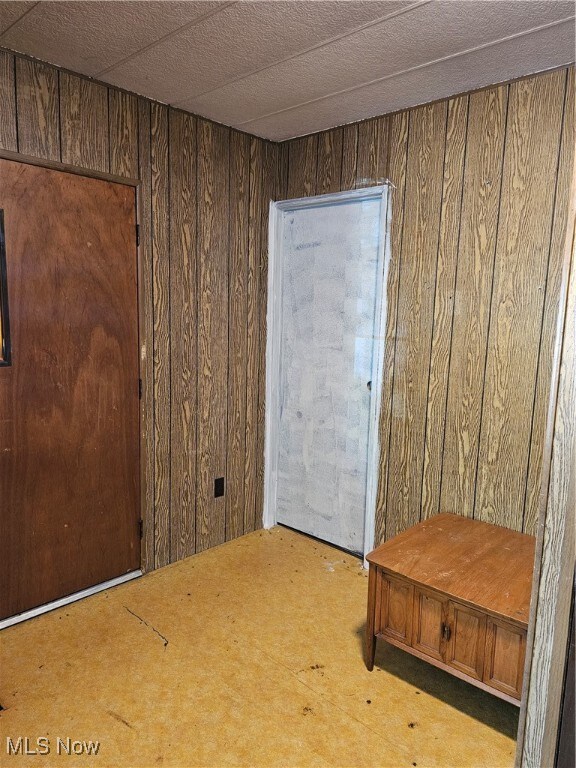 Empty room featuring wood walls