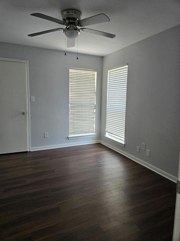 Unfurnished room with ceiling fan, baseboards, an