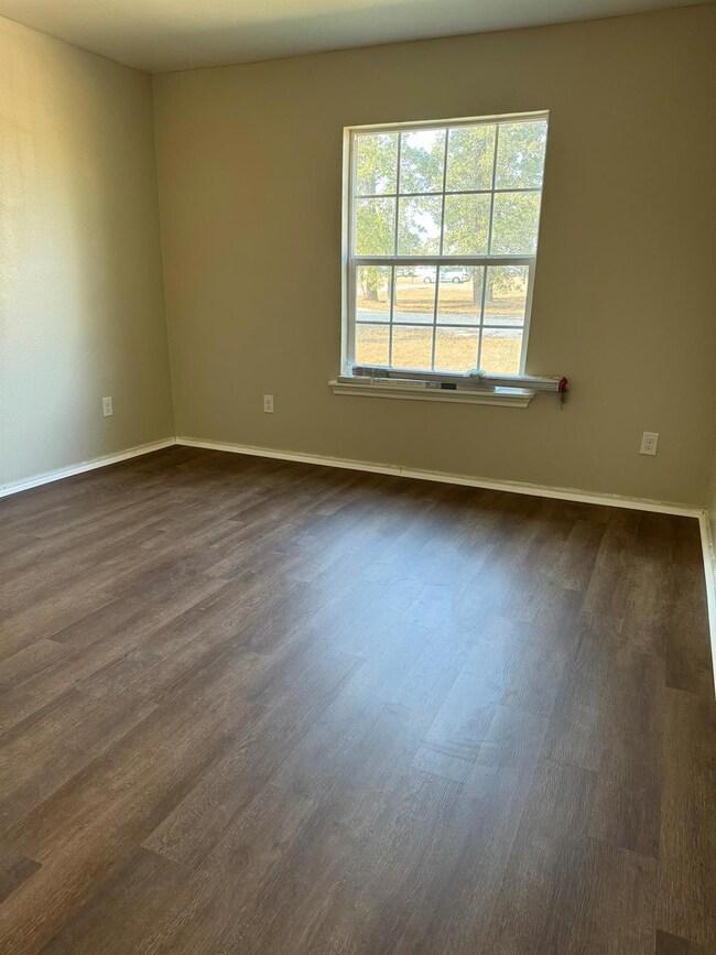 Spare room with dark wood-style flooring and base
