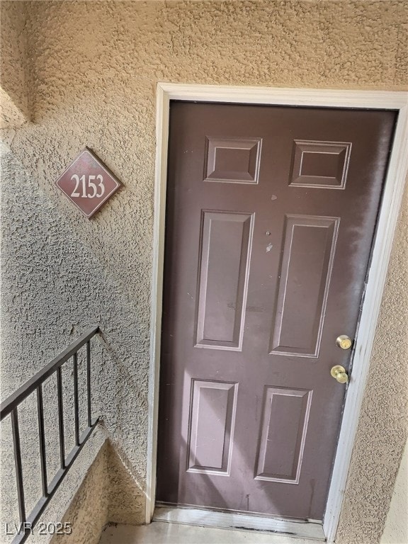 Property entrance with stucco siding