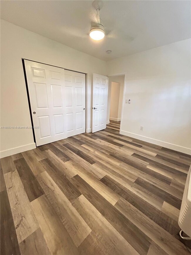Bedroom showing closet and access to living room