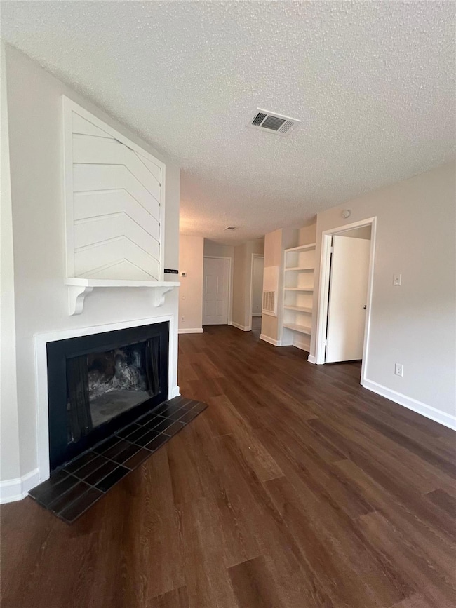 Unfurnished living room with wood finished floors