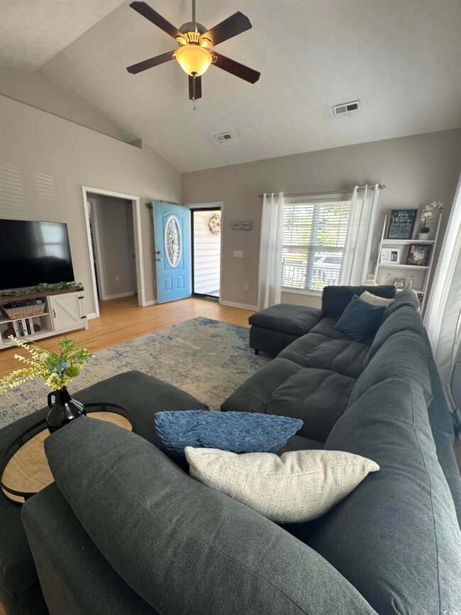 Living area with light wood-style flooring, lofted