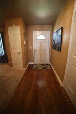 Foyer with hardwood floors and coat closet