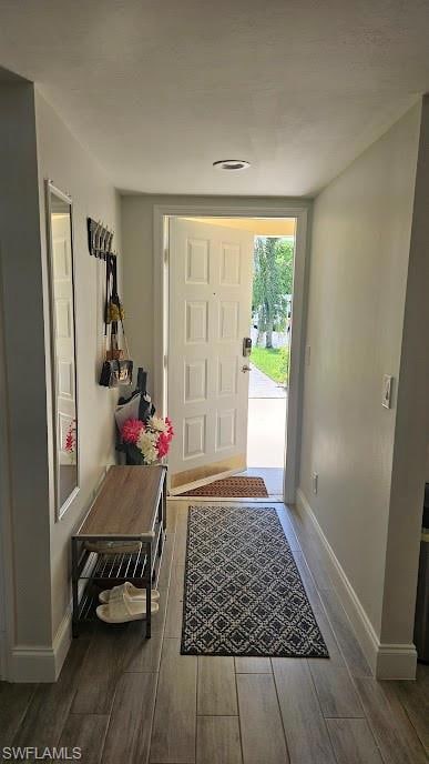 Entryway with wood finished floors and baseboards