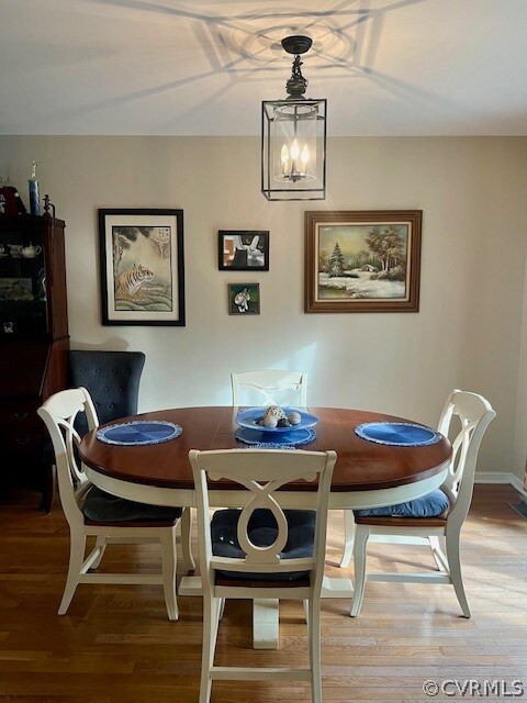 Dining room featuring a notable chandelier and har
