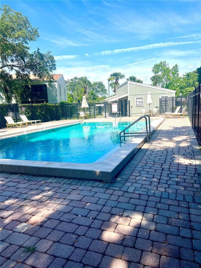 View of Pool and paver  pool deck, and clubhouse