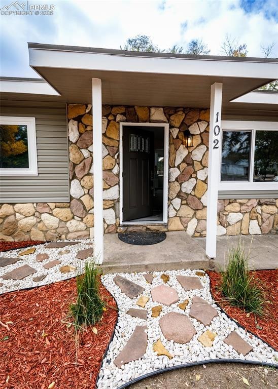 View of exterior entry featuring stone siding