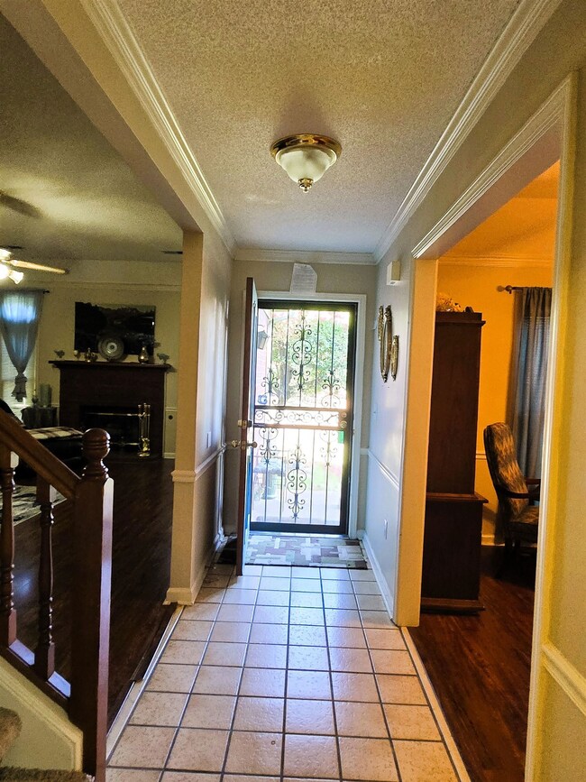 Entryway featuring a textured ceiling, hardwood / 