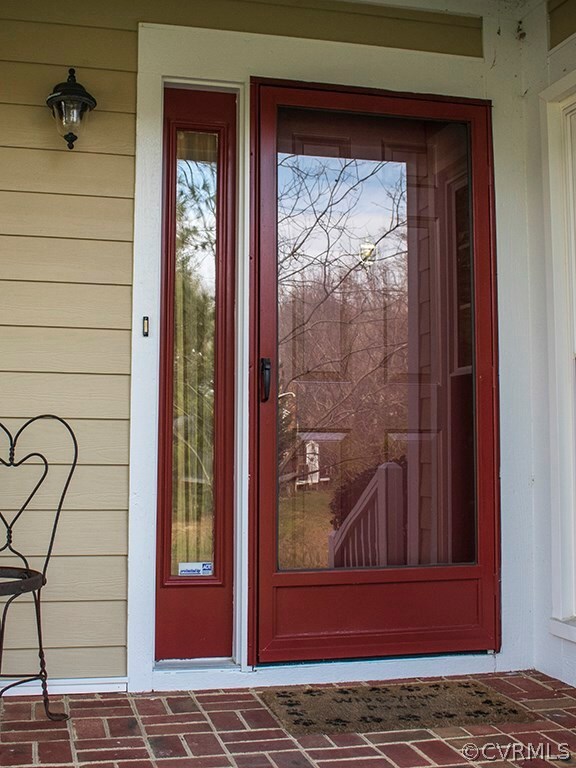 Inviting Brick Porch and warm red Door says...Come