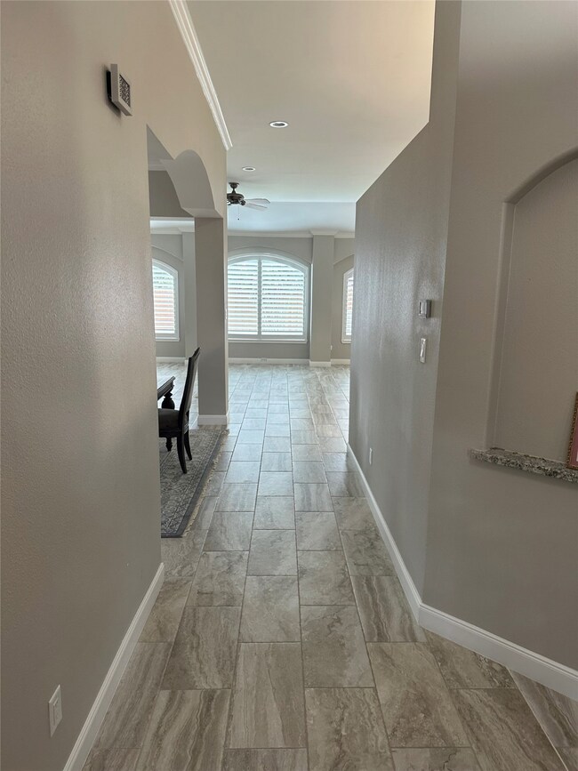 Nice entry way with high ceilings leading into ope