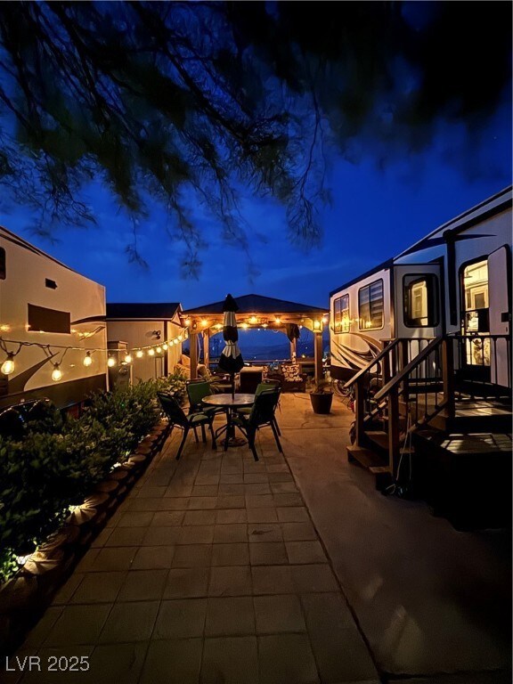 Patio at twilight featuring outdoor dining space