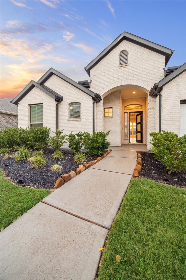 This is an elegant single-story brick home featuri