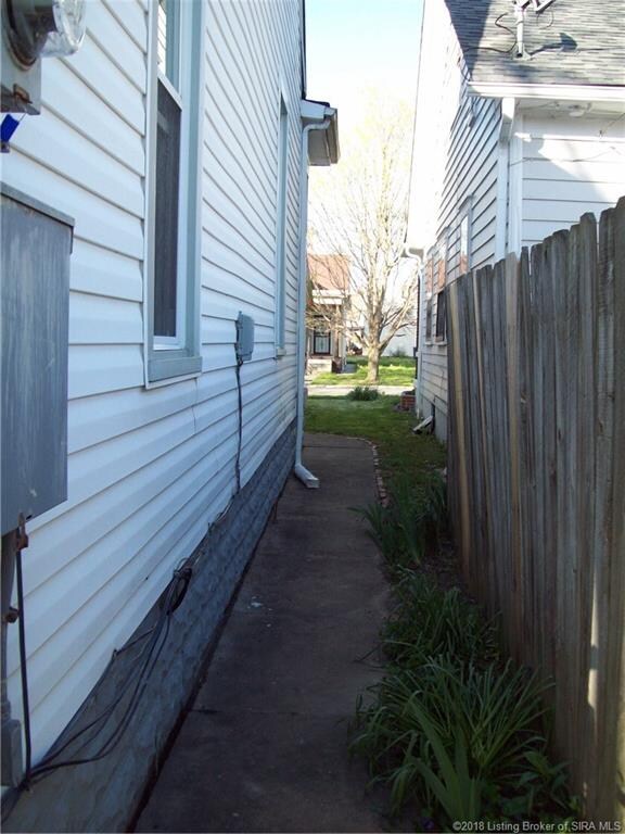 paved walkway leading from backyd to front