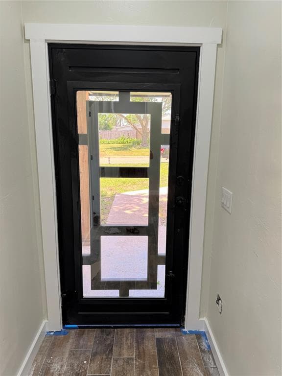 Foyer entrance with wood finished floors and baseboards