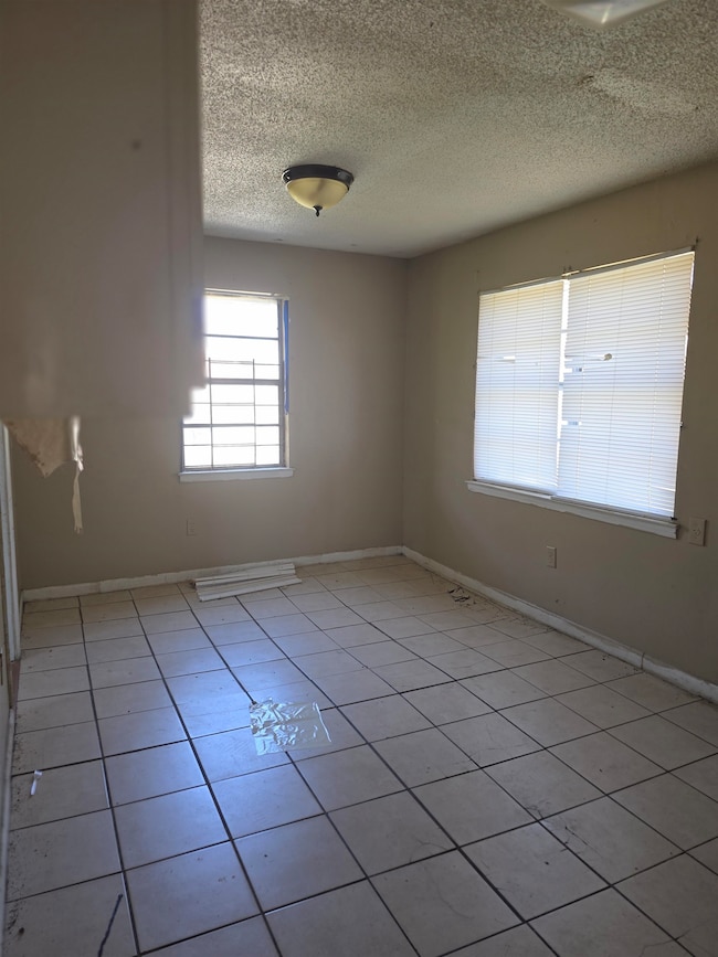 Unfurnished room featuring light tile patterned fl