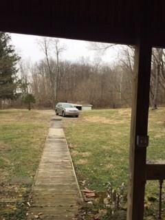 View from the front door to the left is SR 37 and to the right is the wooded area and after the wooded area is the tillable land.